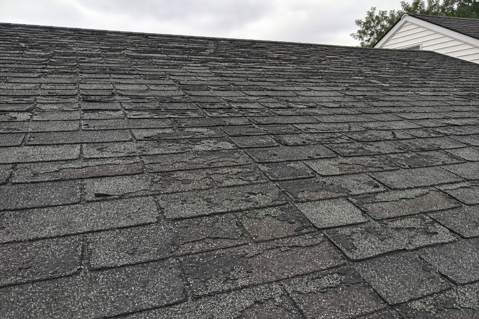 Old weathered roof shingles showing age and wear